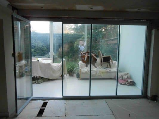 Frameless slide and stack doors with ventilation when open. 